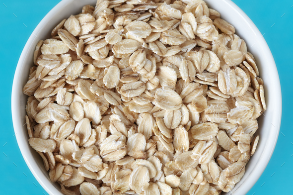 Close up picture of organic oat flakes in a bowl, selective focus. - Stock Photo - Images