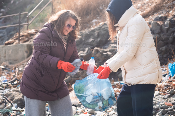 volunteers taking action against ocean plastic problem. Collect waste and garbage for recycling.