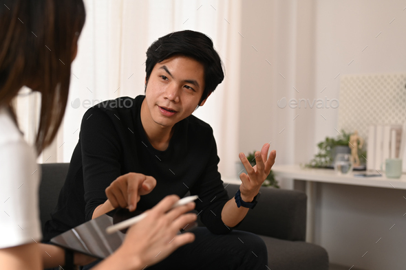 Young asian man talking with psychologist at medical appointment. Psychotherapy and mental health