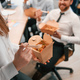 Group of coworkers are eating food from eco boxes in the office together - PhotoDune Item for Sale