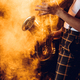 cropped shot of expressive young musician playing saxophone in smoke - PhotoDune Item for Sale