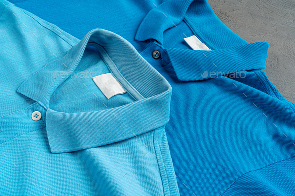 Row of white t-shirts on hangers on rack Stock Photo by FabrikaPhoto