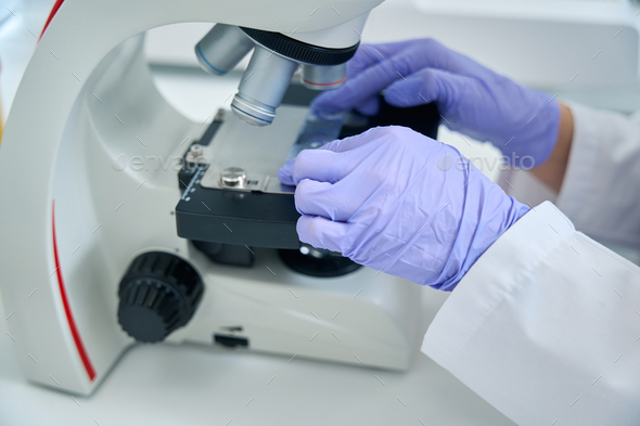 Geneticist laboratory assistant studies biomaterial for a dna test