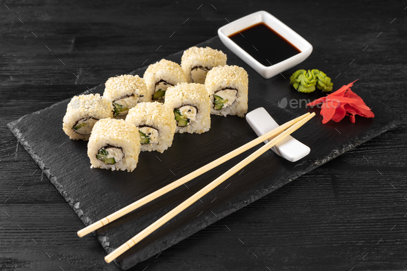 Sushi Roll Philadelphia With Salmon, Sesame Seeds, Avocado, Cream Cheese On Black Slate Background