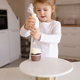 Little kid girl making cupcakes with cream cheese at home - PhotoDune Item for Sale