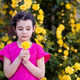 Cute little kid girl holding yellow rose flower in garden outdoor  - PhotoDune Item for Sale