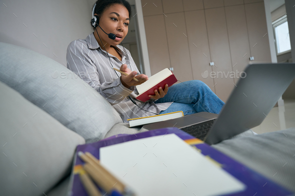 African american woman, student of video courses, studies at home