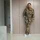 Happy military woman stands in a cozy living room - PhotoDune Item for Sale