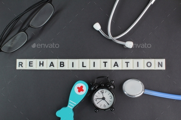 stethoscope, alarm clock, glasses and the word alphabet rehabilitation ...
