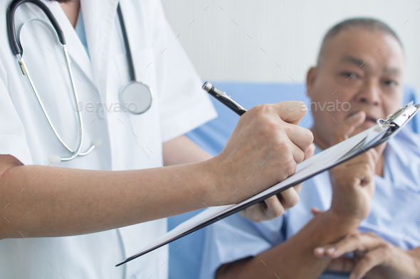 doctor asking and writing on sheet, patient interview and history taking