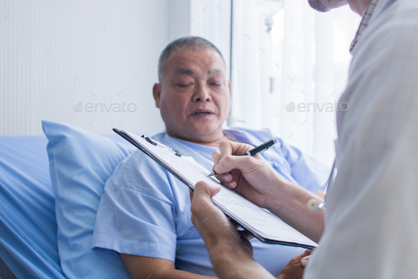 Doctor ask old patient man for symptoms and problem on body, writing information on medical paper