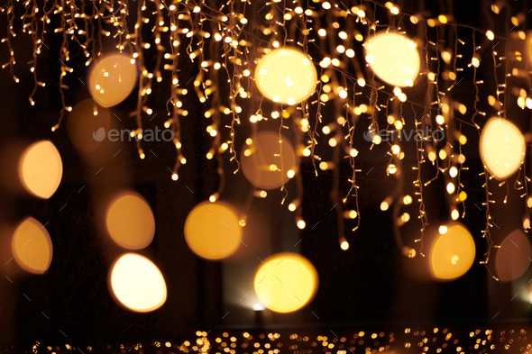 Yellow lights bokeh from christmas holiday garlands, blurred festive background, abstract lights - Stock Photo - Images