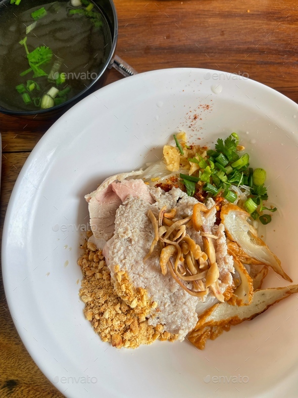 Thai egg noodle with bbq pork and wonton. Stock Photo by Jsttanrak