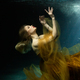 Woman in dress in a state of levitation under the deep waters of the ocean - PhotoDune Item for Sale