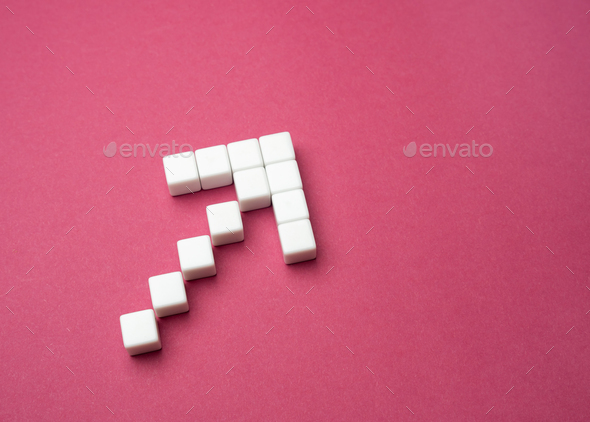 Arrow made of blocks on a gray background. Set a course. Leadership skills.  - Stock Photo - Images
