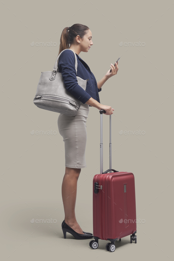 Traveler woman holding a smartphone - Stock Photo - Images