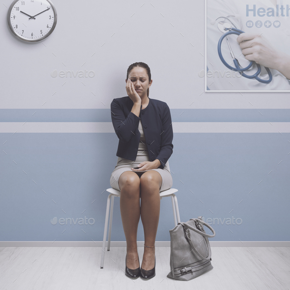 Woman with toothache at the hospital - Stock Photo - Images