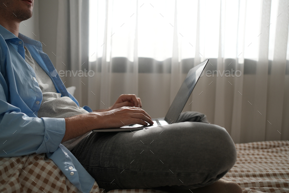 Happy businessman using laptop sending email working at home