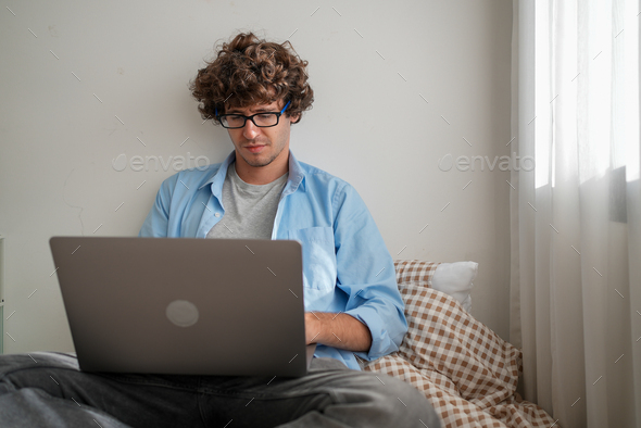 Happy businessman using laptop sending email working at home