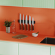 Kitchen countertop in bright orange and green colours with knives, stove and sink, decoration - PhotoDune Item for Sale