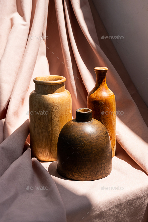 Wooden vases on textile background. Aesthetic vintage home decor collection.