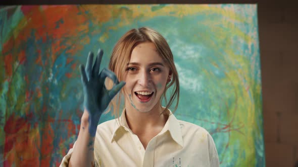 Girl Artist Shows Okay Sign. Art Studio. Her Hand In Paint. alt