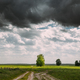 Dramatic Dark Sky On Horizon Above Rural Landscape Meadow. Heavy Rain Clouds Sky Above Grassland - PhotoDune Item for Sale