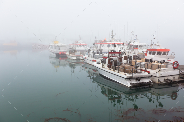 Fishing vessel in a foggy misty morning - Stock Photo - Images