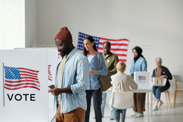 Group of young multicultural voters standing in queue in polling place - Stock Photo - Images