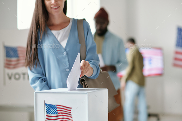 Cropped shot of young woman in casualwear casting ballot paper into box - Stock Photo - Images