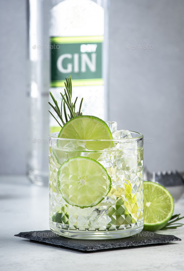Gin tonic classic cocktail drink with dry gin, bitter tonic, lime and