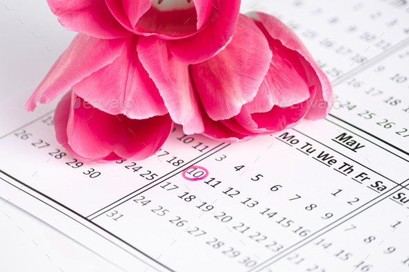 Mothers Day. Calendar with a marked date and pink flowers. A reminder of the holiday. - Stock Photo - Images