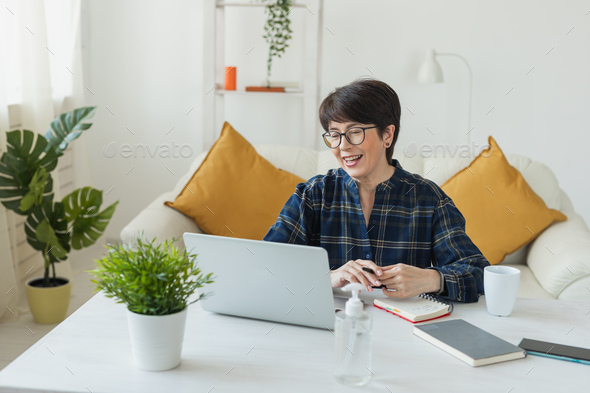 Work online remote from home concept. Woman relaxing in pajama while video call meeting - Stock Photo - Images