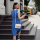 Pregnant woman walking through the city in a blue dress - PhotoDune Item for Sale