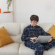 Businesswoman working on laptop computer sitting at home in pajama home wears and managing her - PhotoDune Item for Sale