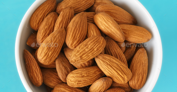 Close up picture of organic almonds in a bowl, selective focus. - Stock Photo - Images