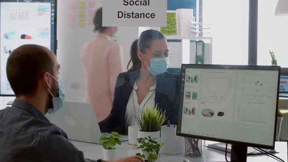 Businessman Looking at Financial Graphs on Computer Display alt