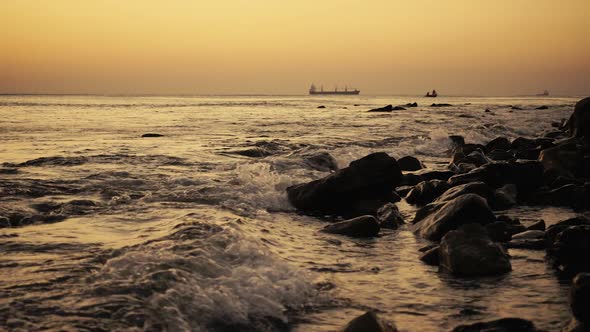 Ships in the Sea and Fishermen in a Boat at Sunset 