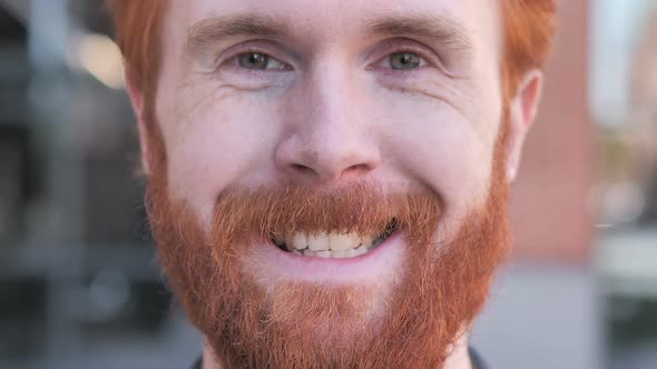 Close Up of Smiling Redhead Beard Young Man Face alt