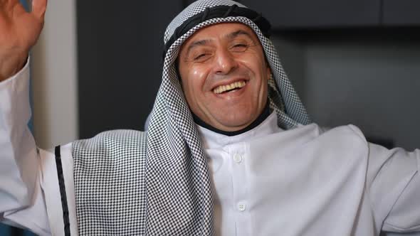 Front View Portrait of Cheerful Middle Eastern Handsome Man in Traditional Dishdasha and Chequered alt