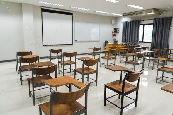 School classroom with many wooden chairs well-arranged in rows with no ...