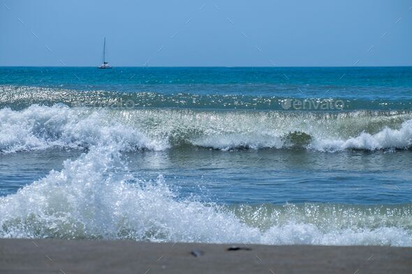 Ocean waves crashing on sandy beach. Sea waves breaking on Maditerranean's shore. - Stock Photo - Images