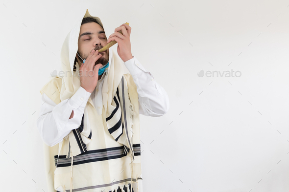 Orthodox Jewish man blowing the horn for the Rosh Hashanah holiday