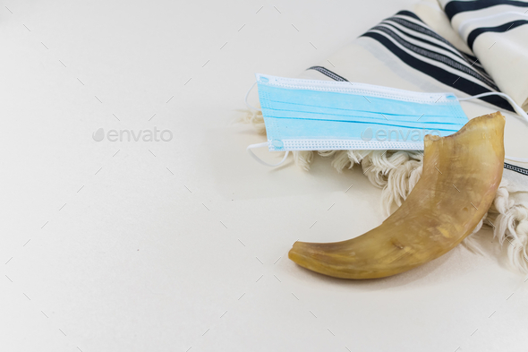 Closeup shot of the shofar and the facemask on the prayer shawl