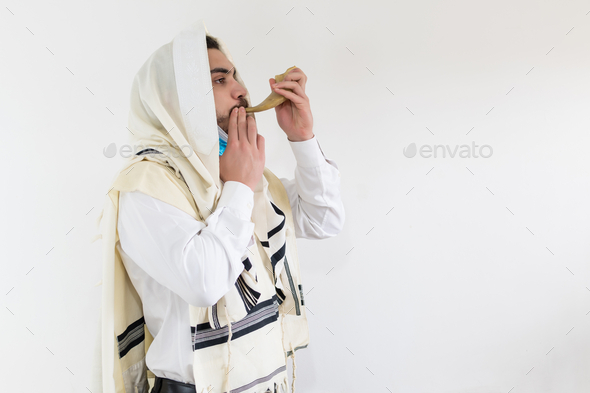 Orthodox Jewish man blowing the horn for the Rosh Hashanah holiday