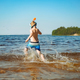  boy wearing snorkel mask running into water. Vacation on sea side. Happy childhood. - PhotoDune Item for Sale