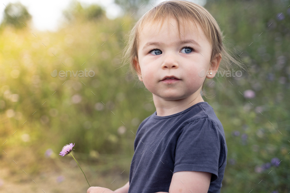 Little girl turning with innocent face outdoors