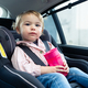 Girl looking at camera while drinking water in a car - PhotoDune Item for Sale