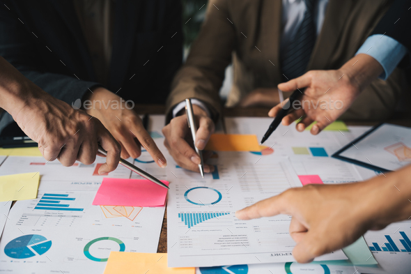 Close-up of Business team hands pointing a pie chart together on the data sheet, statistics and team