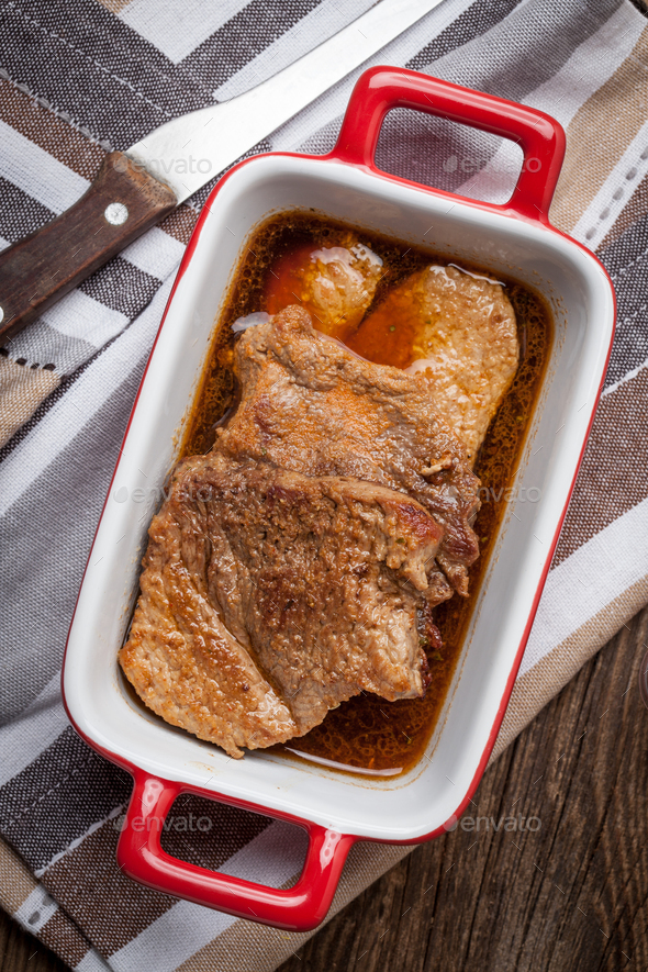 Braised pork in gravy. Stock Photo by foto_pstryki PhotoDune